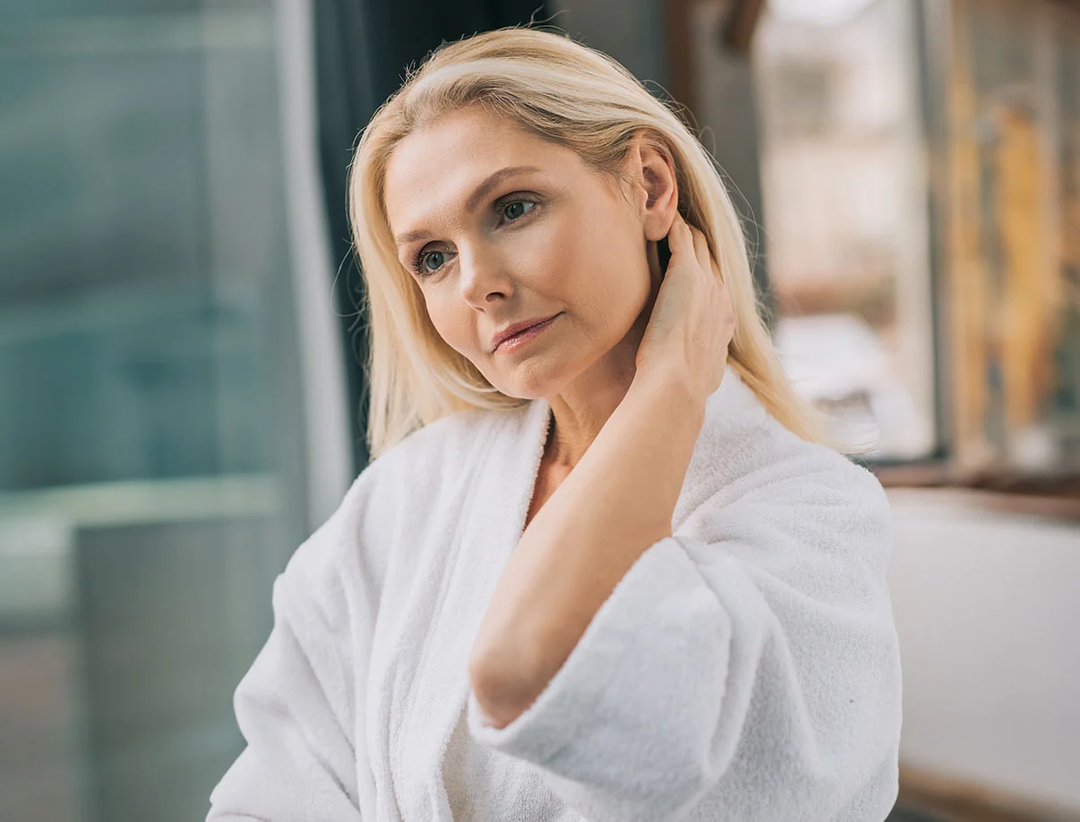 A tranquil scene of a woman sitting in a sauna setting, relaxed, with modern design element - Infrared Sauna in West Hollywood, CA